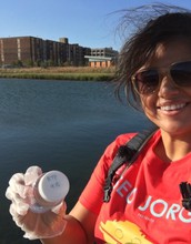 student holds a water sample